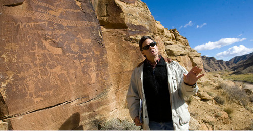 Al Hartmann  |  The Salt Lake Tribune  
Jim Felton, communication manager with Bill Barrett Corp., toured some of the world famous rock art sites along the Nine Mile Road.  This one is called the Crane Panel, which sits high above the road.  Bill Barrett Corp. operates many gas wells in the area and has agreed to fund cultural resources field work, monitoring, rock art conservation and mitigation plans.