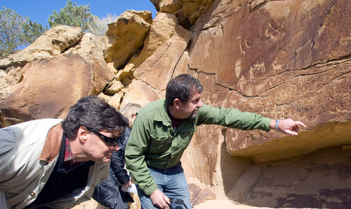 Al Hartmann  |  The Salt Lake Tribune 
Jim Felton, communication manager for Bill Barrett Corp., left, and Jerry Spangler, of the Colorado Plateau Archaelogical Alliance, look for rock art below a large panel called the Owl panel in Nine Mile Canyon.  Bill Barrett Corp. operates many gas wells in the area and has agreed to fund cultural resources field work, monitoring, rock art conservation and mitigation plans.