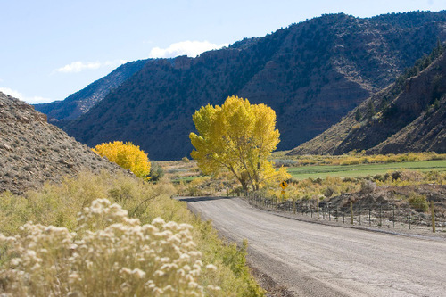 Al Hartmann  |  The Salt Lake Tribune  
A dirt road runs the length of  Nine Mile Canyon.  Just above the road are hundreds of examples of rock art.  Bill Barrett Corp. operates many gas wells in the area and has agreed to fund cultural resources field work, monitoring, rock art conservation and mitigation plans.