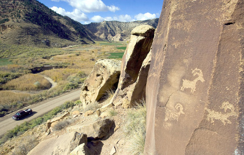 Al Hartmann  |  The Salt Lake Tribune  
A truck makes its way along dirt road in Nine Mile Canyon.  Just above the road are hundreds of examples of rock art like these.  Bill Barrett Corp. operates many gas wells in the area and has agreed to fund cultural resources field work, monitoring, rock art conservation and mitigation plans.