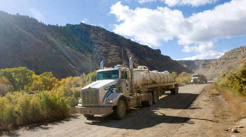 Al Hartmann  |  The Salt Lake Tribune
Bill Barrett Corp. water trucks make their along the dirt road in Nine Mile Canyon. Just above the road are hundreds of examples of rock art that can be impacted by the dust thrown up by the large trucks. Bill Barrett Corp. operates many gas wells in the area and has agreed to fund cultural resources field work, monitoring, rock art conservation and mitigation plans.