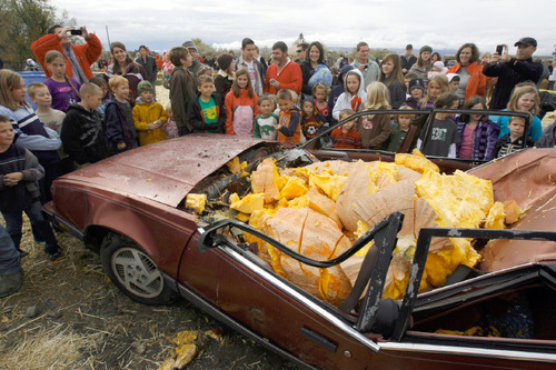 Francisco Kjolseth  |  The Salt Lake Tribune&#xA;The year's state record pumpkin of 1,169 pounds fills a car Oct. 23 after being dropped from a 175-foot crane at Hee Haw Farms in Pleasant Grove, completely destroying a Pontiac 6000. The pumpkin was grown by Matt McConkie from Mountain Green and it is calculated that the descent of the giant pumpkin reached a top speed of 67.1mph for 3.1 seconds before meeting its demise.