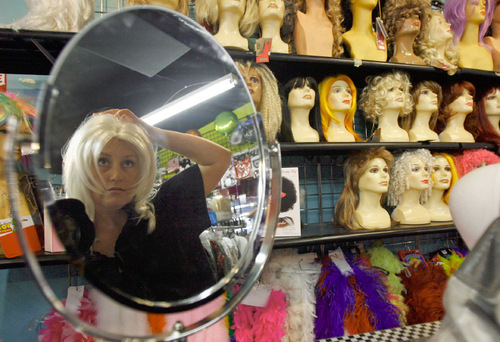Francisco Kjolseth  |  The Salt Lake Tribune
Melanie Erwin tries on a wig at Pib's Exchange in Sugar House Wednesday as she tries to assemble the outfit worn by the female lead character from the Hitchcock classic 