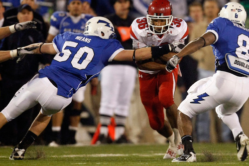 Chris Detrick  |  The Salt Lake Tribune 
Utah Utes running back Eddie Wide #36 runs past Air Force Falcons linebacker Alex Means #50 and Air Force Falcons cornerback Reggie Rembert #8 during the first half of the game at Falcon Stadium Saturday October 30, 2010.   Utah is winning the game 14-10.