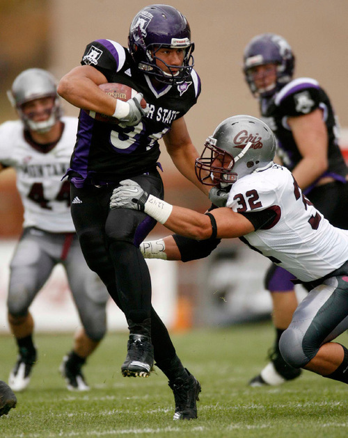 Trent Nelson  |  The Salt Lake Tribune&#xA;Weber State's Vaingamalie Tafuna eludes the grasp of Montana's Alex Shaw in the first half with Montana's Erik Stoll hanging on, Weber State vs. Montana, college football Saturday, October 30, 2010.
