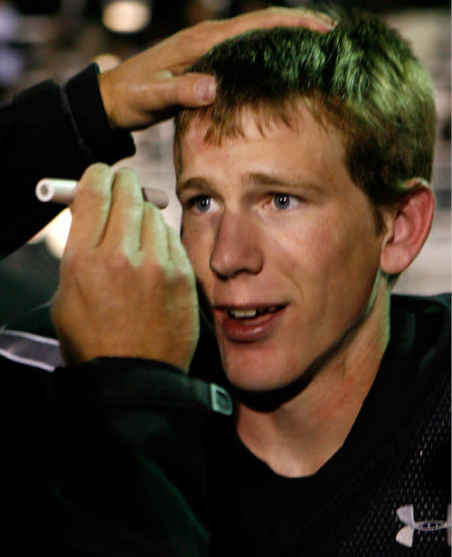 Alta High quarterback Eric Emery is examined after a tough tackle by the Pleasant Grove defense in the first half in Sandy, Utah on Friday night.&#xA;Stephen Holt / Special to the Tribune