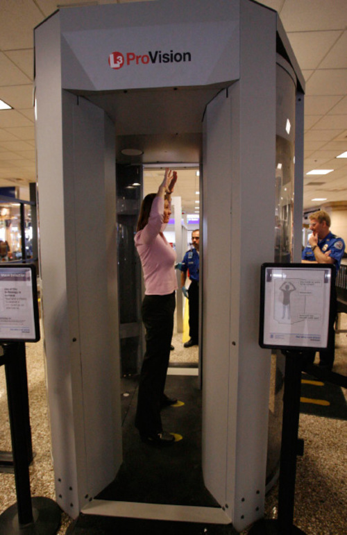(Photo by Leah Hogsten | Tribune file photo) TSA program analyst and instructor Sherrie Soto (in pink) from Washington, D.C.stands in the Millimeter Wave Detection unit as SLC TSA security officers learn earlier this year how to instruct airline passengers through the airports newest screening process.