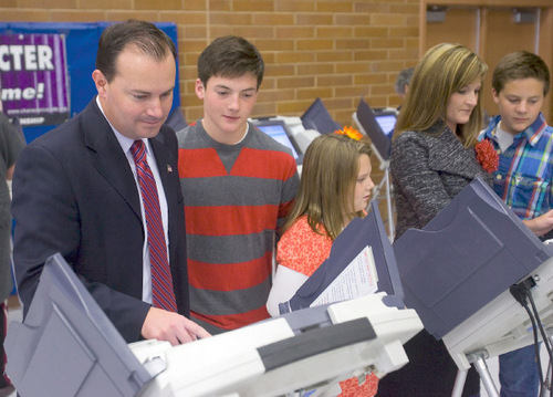 Al Hartmann  |  The Salt Lake Tribune&#xA;Republican candidate for U.S. Senate Mike Lee, left,  votes at Alpine Elementary School early Tuesday morning with his son James, daughter Eliza, wife Sharon and son John.