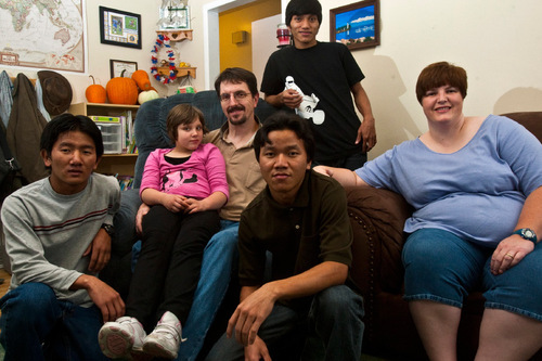 Chris Detrick  |  The Salt Lake Tribune &#xA;Ray and Sarah Osborn  pose for a portrait with their adopted children, (l-r)  Khup, 18, Allie, 9,  Kap Tung, 17, and Than Htay, 18, at their home in West Valley City Thursday November 4, 2010.   Sarah and Ray Osborn are foster parents to three refugee boys from Myanmar. They also have an adopted daughter. The family is being honored by Catholic Community Services at a Nov. 10 banquet.