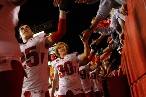 Chris Detrick  |  The Salt Lake Tribune 

Utah Utes cornerback Mike Honeycutt (#25) and kicker Nick Marsh (#30) high-five fans after the game at Jack Trice Stadium in Ames, Iowa on Saturday, Oct. 9, 2010.  The Utes defeated Iowa State 68-27.