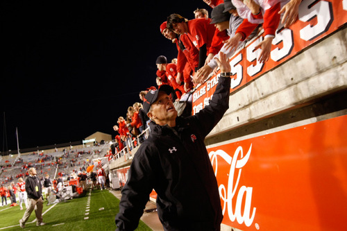 Chris Detrick  |  The Salt Lake Tribune 
Utah coach Kyle Whittingham high-fives fans after beating Colorado State. All four home wins this year were virtual sellouts.