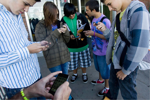 Djamila Grossman  |  The Salt Lake Tribune&#xA;&#xA;From left: Kearns High School sophomores Rafael Rivas, Kayla Tomascewski, David Palacios, Robert Jackson and Sage Cordova check out the iPod Touch they received along with other students at the school in Kearns, Friday, November 5, 2010. The iPods are part of an educational grant the school has received and they will be used in class.