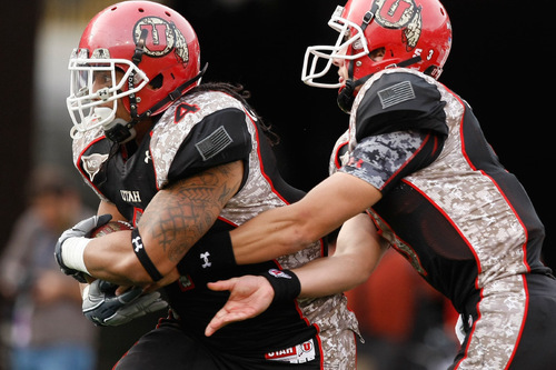 Chris Detrick  |  The Salt Lake Tribune &#xA;Utah Utes running back Matt Asiata #4 gets the ball from Utah Utes quarterback Jordan Wynn #3 during the second half of the game at Rice-Eccles Stadium Saturday November 6, 2010.  TCU defeated Utah 47-7.