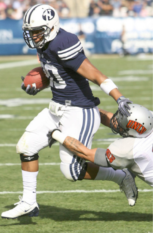 Leah Hogsten  |  The Salt Lake Tribune
BYU running back Joshua Quezada (20) leaves UNLV's Mike Clausen and scores the first touchdown of the game.  The BYU Cougars  leads UNLV  35-0 at the half during their Mountain West Conference game at LaVell Edwards Stadium Saturday, November 6, 2010, in Provo.