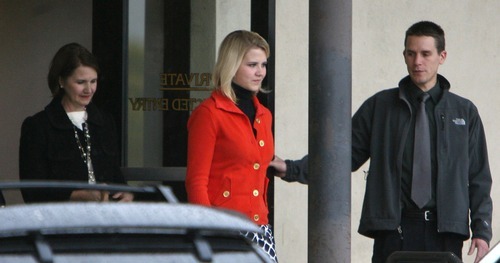 Steve Griffin  |  The Salt Lake Tribune

 Followed by her mother Lois Smart,Elizabeth Smart  leaves out  the back entrance of the Frank E. Moss Federal Courthouse in Salt Lake City Monday, November 8, 2010 after the first day of the trial for Elizabeth's suspected kidnapper, Brian David Mitchell.