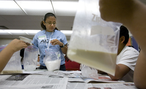 Steve Griffin  |  The Salt Lake Tribune

Twenty chemical engineers from across the United States visited Bryant Middle School in Salt Lake City, to talk to students about careers in chemical engineering and perform experiments. Here Sally Torres, an engineering student at Prairie View A & M University in Crosby, Texas helps seventh graders with an experiment making ice cream in plastic bags. The engineers are in Salt Lake City for the annual conference of the American Institute of Chemical Engineers in  Salt Lake City Monday, November 8, 2010.