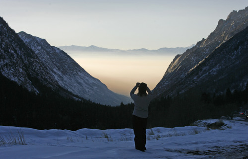 Rick Egan   |  The Salt Lake Tribune

Kim Atno stops to take a picture of the Salt Lake Valley from Little Cottonwood Canyon Road, on her way home from skiing at Alta, Jan. 11, 2010.