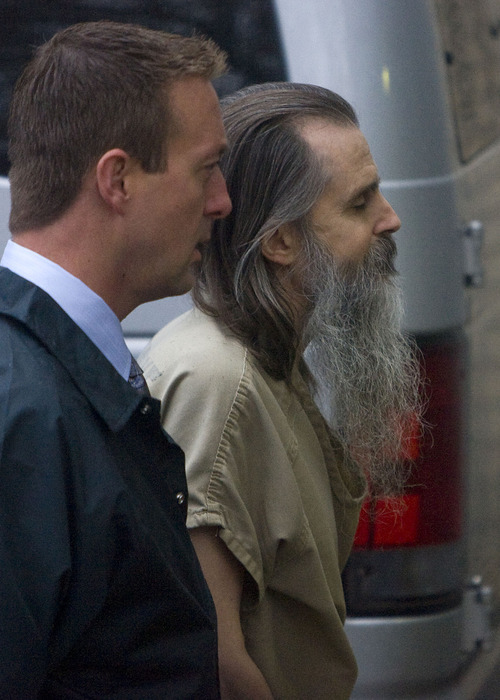 Al Hartmann  |  The Salt Lake Tribune
Brian David Mitchell, right, is lead into Frank Moss Federal Courthouse in Salt Lake City on Monday morning by a federal marshall as his trial in the kidnapping of Elizabeth Smart resumes.