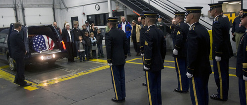 Al Hartmann  |  The Salt Lake Tribune
Army honor guard carries casket with the remains of  Cpt. George Willard Grismore to a waiting hearse at an air cargo warehouse at Salt Lake City International Airport on Wednesday morning.  Grismore's plane went down in Leyte, Phillipines, on March 12, 1945.  His remains were identified by a DNA match from a family member nearly 65 years later.