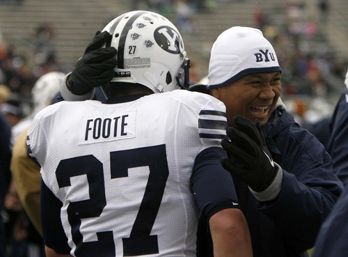Trent Nelson  |  The Salt Lake Tribune
Mark Atuaia celebrates with BYU running back David Foote (27) after his fourth-quarter touchdown against Colorado State on Nov. 13, 2010. BYU won 49-10.