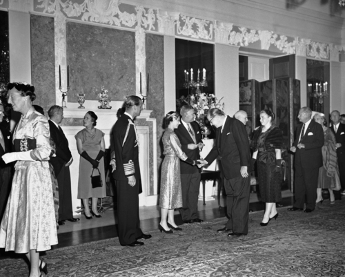 Secretary of Agriculture Ezra Taft Benson bows as he meets Queen Elizabeth II in receiving line at British Embassy reception in Washington on Oct. 18, 1957. (AP Photo)