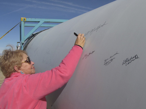Mark Havnes  |  The Salt Lake Tribune
Iona Whittaker, a former Milford resident who first suggested building a wind farm nearby, signs a turbine blade during a Wednesday ceremony to celebrate operator First Wind's expansion of the facility.
