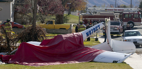 Jason Olson  |  Special to The Tribune  
Emergency crews respond to the scene of a plane crash Wednesday near Wilson Elementary School in Payson.