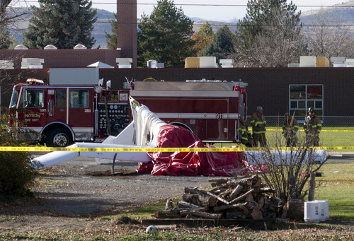 Jason Olson  |  Special to The Tribune  

Emergency personnel respond to the scene of a plane crash near an elementary school in Payson on Wednesday, November 17, 2010.