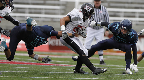 Hurricane's Weston Yardley, center, is tackled by Juan Diego's Cody Sainsbury, left, and Henry Schwab, right, during the 3A high school football championships Friday, Nov. 19, 2010, in Salt Lake City. Juan Diego defeated Hurricane for the 3A title 10-7. (Jim Urquhart/ Special to The Salt Lake Tribune)