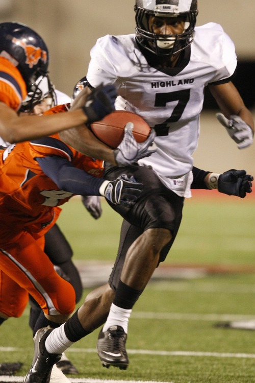 Chris Detrick  |  The Salt Lake Tribune 
Highland's Napaa Fakahafua #7 runs around Mountain Crest's Moroni Lee #8 and Mountain Crest's Braden Fuller #4 during the first half of the 4A Utah State Championship game at Rice-Eccles Stadium Friday November 19, 2010.  Mountain Crest is winning the game 9-7.