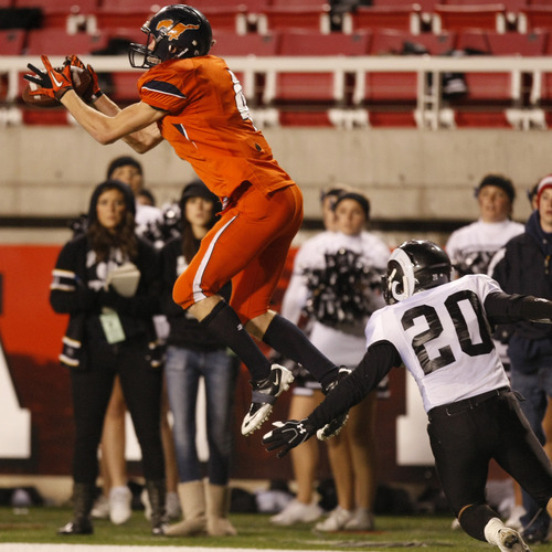 Chris Detrick  |  The Salt Lake Tribune 
Mountain Crest's Braden Fuller #4 makes a catch past Highland's Justin Weaver #20 during the first half of the 4A Utah State Championship game at Rice-Eccles Stadium Friday November 19, 2010.  Mountain Crest is winning the game 9-7.