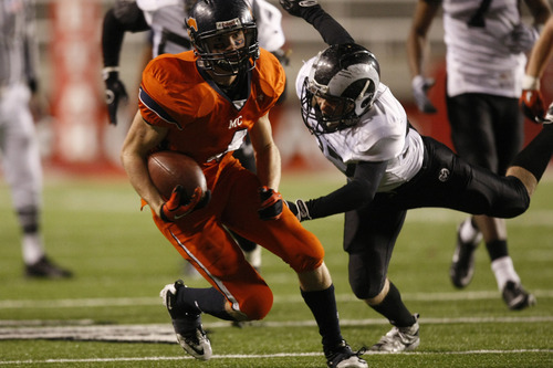 Chris Detrick  |  The Salt Lake Tribune 
Mountain Crest's Braden Fuller #4 runs around Highland's Christian Schulte #37 during the second half of the game the 4A Utah State Championship game at Rice-Eccles Stadium Friday November 19, 2010.  Highland won the game 37-36 in double overtime.