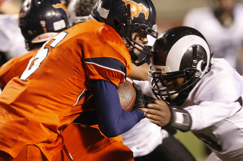 Chris Detrick  |  The Salt Lake Tribune 
Mountain Crest's Nate Rigby #6 runs through Highland's Anthony Smithson #6 during the first half of the 4A Utah State Championship game at Rice-Eccles Stadium Friday November 19, 2010.  Mountain Crest is winning the game 9-7.