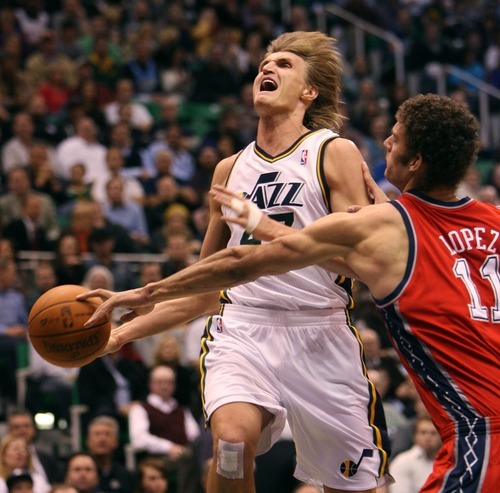 Steve Griffin  |  The Salt Lake Tribune
 
Utah's Andrei Kirilenko gets fouled by New Jersey Nets center, Brook Lopez,  as he drives the lane during first half action of the Utah Jazz versus New Jersey Nets basketball game at EnergySolutions Arena in Salt Lake City Wednesday, November 17, 2010.