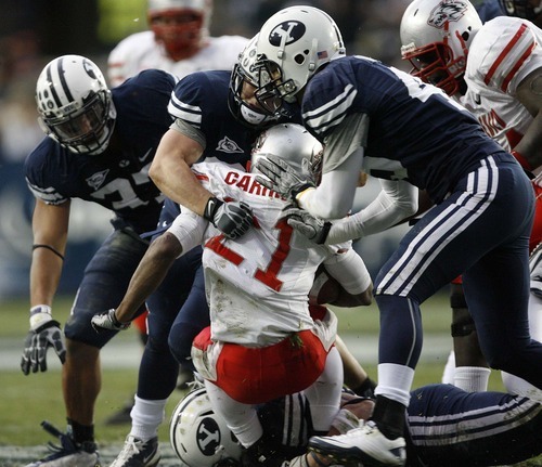 Trent Nelson  |  The Salt Lake Tribune
BYU defensive lineman Vic So'oto (37), BYU defensive back Zeke Mendenhall (30) and BYU linebacker Kyle Van Noy (45) bring down New Mexico's Kasey Carrier during the first half,  BYU vs. New Mexico, Saturday, November 20, 2010.