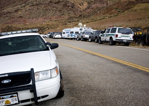 Djamila Grossman  |  The Salt Lake Tribune

Cars from several law enforcement agencies from around the state are parked at the central command center during a search for a suspect in an officer-involved shooting near Moab, Sunday, Nov. 21, 2010. State park ranger Brody Young of Moab was shot Friday and law enforcement officials have been trying to locate the suspect since.