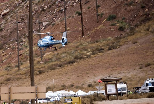 Djamila Grossman  |  The Salt Lake Tribune

A helicopter lands at a staging area near the blocked SR 279 by Moab, from where law enforcement officials search for a suspect in an officer-involved shooting, Sunday, Nov. 21, 2010. State park ranger Brody Young of Moab was shot Friday and law enforcement officials have been trying to locate the suspect since.