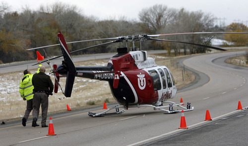 Francisco Kjolseth | The Salt Lake Tribune
A medical helicopter responding to a rollover on I-84 near Ogden Monday made a hard landing after it clipped its tail rotor on a highway reflector post, shutting down westbound traffic.