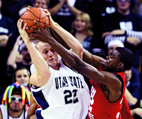 Rick Egan  |  The Salt Lake Tribune
Utah State University's Brady Jardine battles Utah's Shawn Glover for a rebound during a game in Logan on Nov. 22.