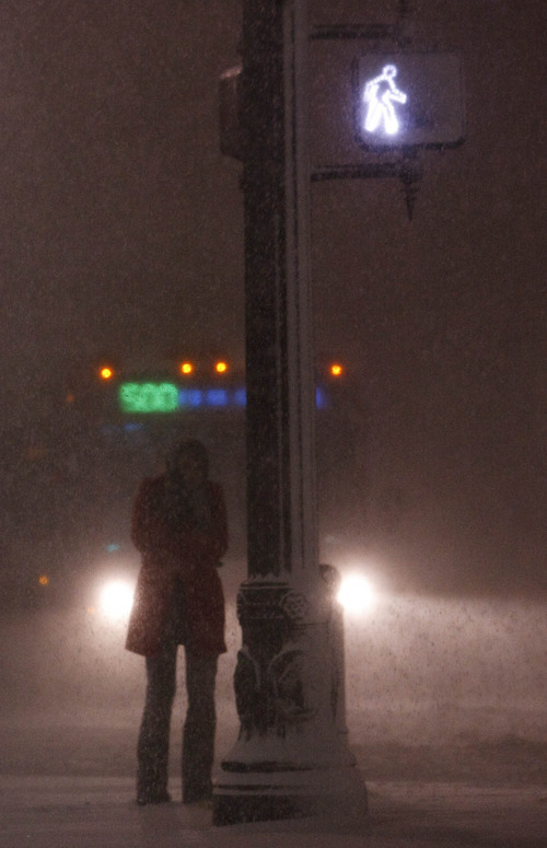 Leah Hogsten  |  The Salt Lake Tribune
 A woman waits to cross the signal at Main St. and 200 South.  A blizzard blew into Salt Lake County just after 5 p.m. Tuesday and was expected to last several hours, according to the National Weather Service. At 6 p.m., the National Weather Service reported that the blizzard should dump snow for up to four hours. Poor visibility, strong winds, blowing snow and dangerous driving conditions were also present throughout northern Utah. Tuesday, November 23, 2010, in SLC.