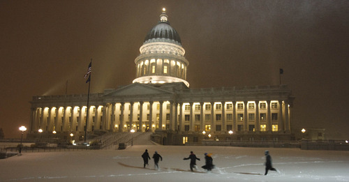 Leah Hogsten  |  The Salt Lake Tribune
People at the Utah Capitol play in the snow on the South side.   A blizzard blew into Salt Lake County just after 5 p.m. Tuesday and was expected to last several hours, according to the National Weather Service. At 6 p.m., the National Weather Service reported that the blizzard should dump snow for up to four hours. Poor visibility, strong winds, blowing snow and dangerous driving conditions were also present throughout northern Utah. Tuesday, November 23, 2010, in SLC.