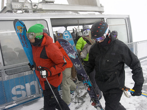 Al Hartmann  |  The Salt Lake Tribune 
Skiers hit the ground running as they exit the tram at Snowbird Wednesday on morning.  Weather at the top of Hiden Peak at Snowbird was -5 degrees, with gusty winds, light snow and low visibility.  It didn't seem to faze the this bunch.