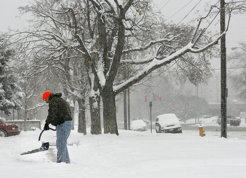 Scott Sommerdorf  |  The Salt Lake Tribune
A man fights a losing battle with keeping his sidewalk clear near 500 East, and 600 South last month in Salt Lake City.