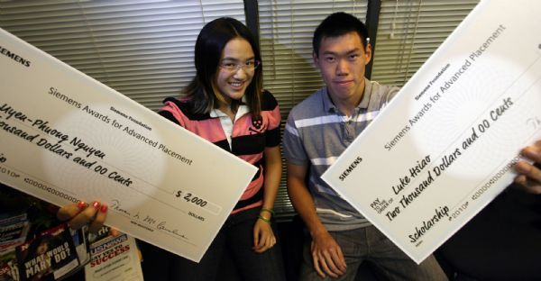 Steve Griffin  |  The Salt Lake Tribune

    Cottonwood High School seniors Uyen-Phuong Nguyen and Luke Hsiao hold up there big fake checks the received for being this year's recipients for the Siemens Award. Each year, the top male and female Advanced Placement student in science and math subjects in each state are given the award for Advanced Placement (SAAP). Students are eligible for the $2,000 scholarship if they receive at least two scores of 5 (that's the best you can get) on AP math and science tests.   Friday Apr 16, 2010.