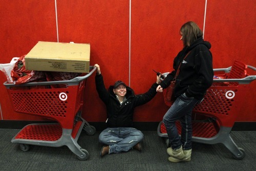 Rick Egan   |  The Salt Lake Tribune

Eric Gonzales, Salt Lake City, waits with his carts at  the Super Target in Midvale,   along with Tina Peterson, American Fork, as they wait for their friends to make it through the long lines, at 5 am, Friday, November 26, 2010.  Shoppers started lining up at 7pm on Thursday, for the 4 am opening of the store.