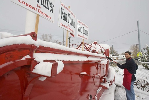 Paul Fraughton | The Salt Lake Tribune 
Van Turner, a city councilman from Salt Lake City's District 2, on Wednesday sweeps the snow off an antique firetruck parked in front of the Hook & Ladder burger restaurant, one of several businesses he owns and operates on the west side.