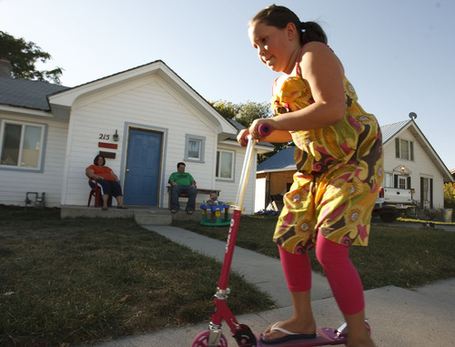 Leah Hogsten  |  The Salt Lake Tribune

Tremonton residents Darcy and David Porter watch their daughter Zoey, 9, ride her new razor along the sidewalk in front of their home on Zoey's birthday on Sept. 30.