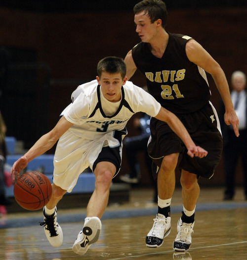 Chris Detrick  |  The Salt Lake Tribune 
West Jordan's Chase Hawker #3 runs around Davis' Trever Webb #21 during the basketball game at West Jordan High School Tuesday November 30, 2010.