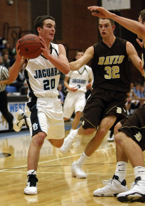 Chris Detrick  |  The Salt Lake Tribune 
West Jordan's Seth Barrus #20 is guarded by Davis' Riley Watts #32 during the basketball game at West Jordan High School Tuesday November 30, 2010.