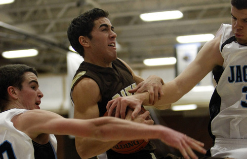 Chris Detrick  |  The Salt Lake Tribune 
Davis' Michael Kamalu #11 is guarded by West Jordan's Seth Barrus #20 and West Jordan's Skyler Ford #32 during the basketball game at West Jordan High School Tuesday November 30, 2010.